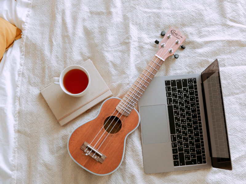 Someone learns to play ukulele online.