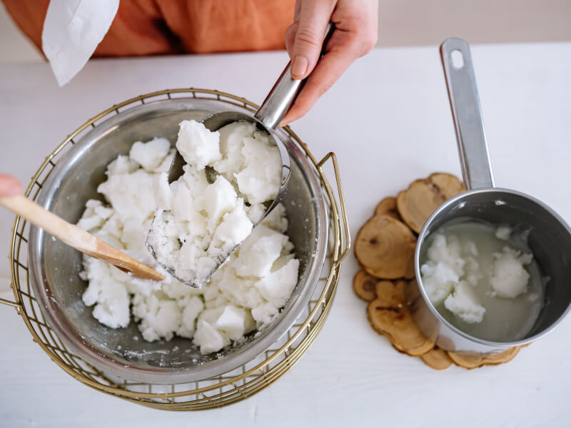 Person melting soy wax to make homemade candles.