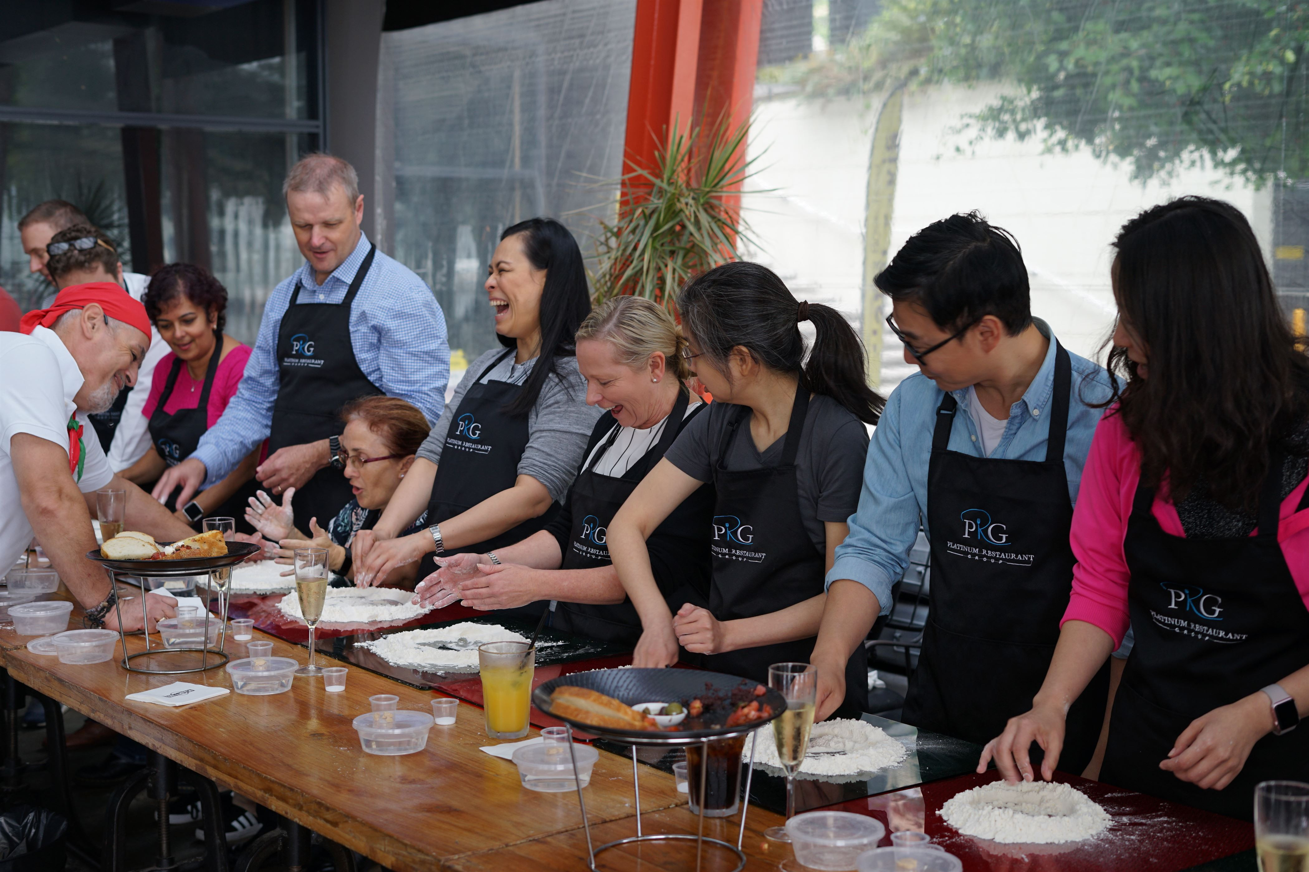 A group of colleagues at a pizza making class