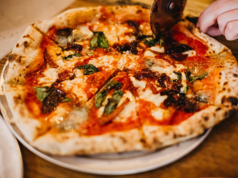 A freshly cooked handmade margherita pizza on a plate