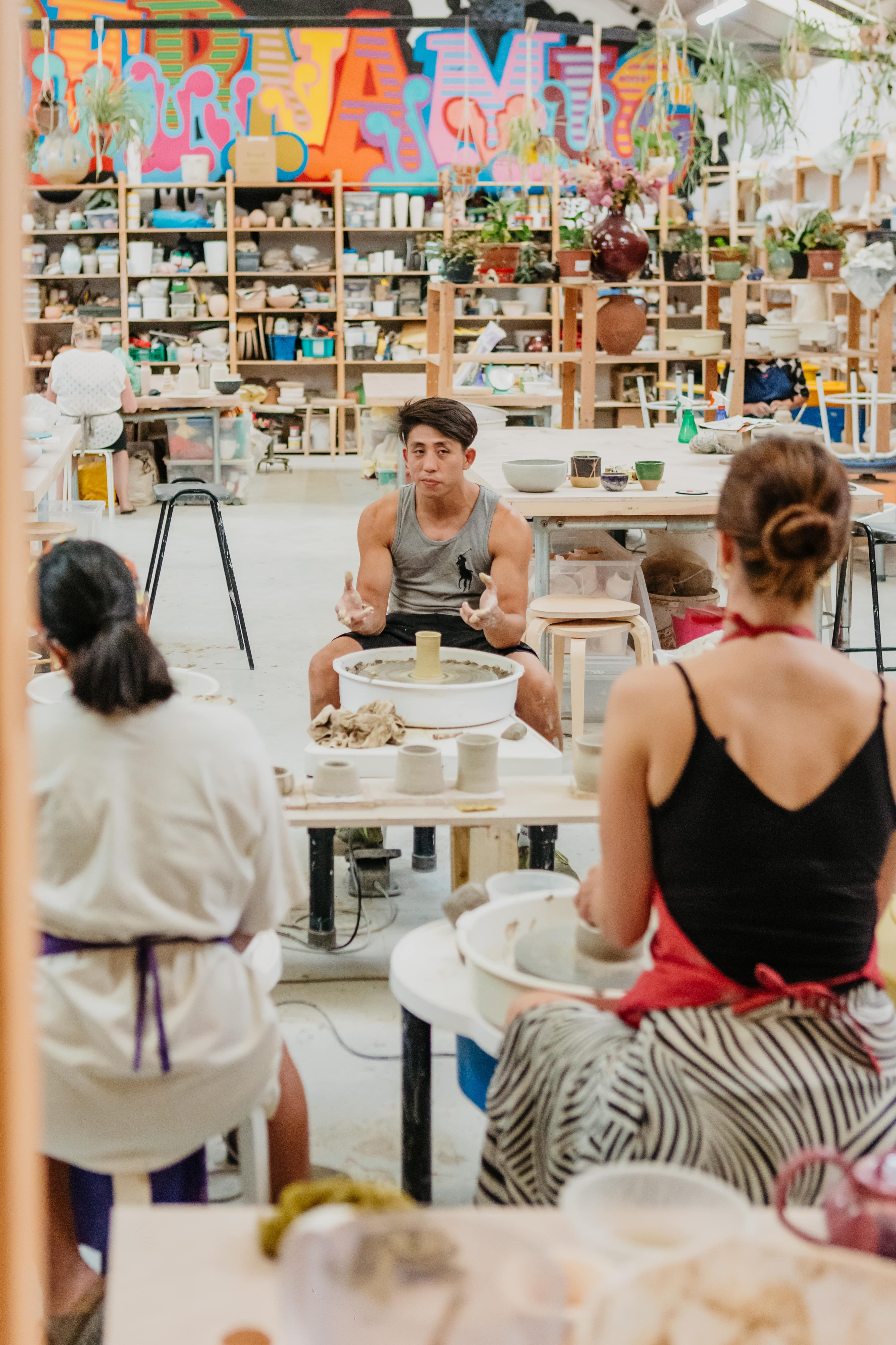 Great Pottery Throwdown Contestant Nam Tran teaching a pottery class.
