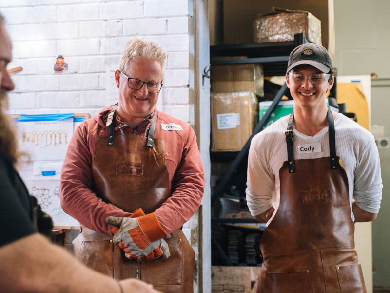 Dad and son smiling in a practical workshop