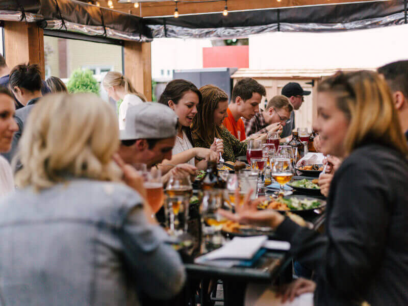 A group of people sitting at a table enjoying a meal together