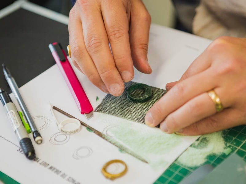 Hands molding a ring in a jewellery making class
