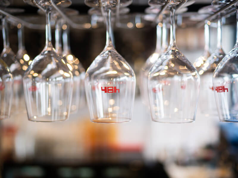 Rows of wine glasses hanging up