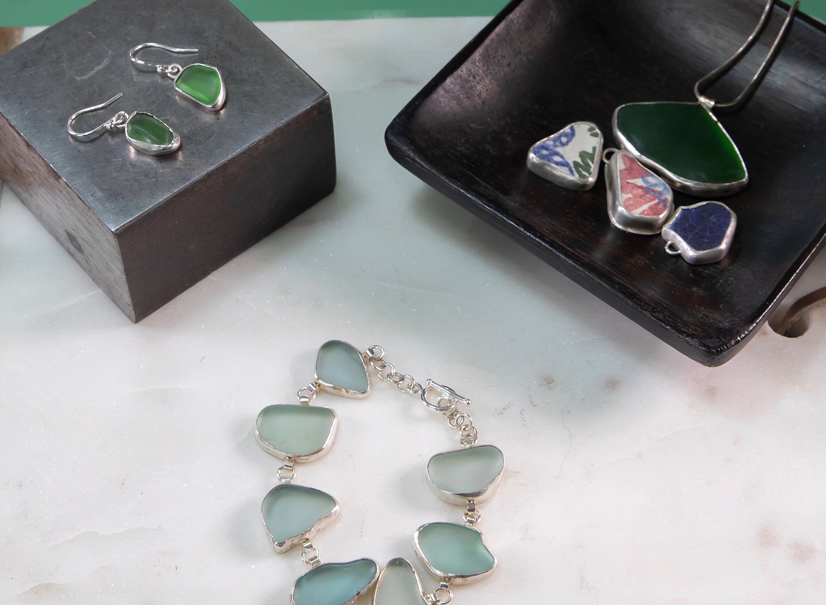 Bracelets, earrings and necklace made from sea glass.