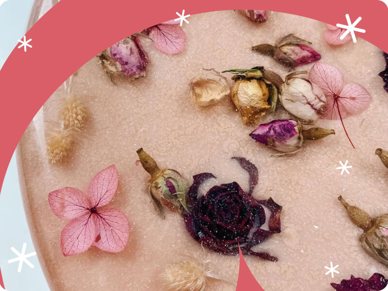 A picture of a piece of resin art with flowers, leaves and buds inside