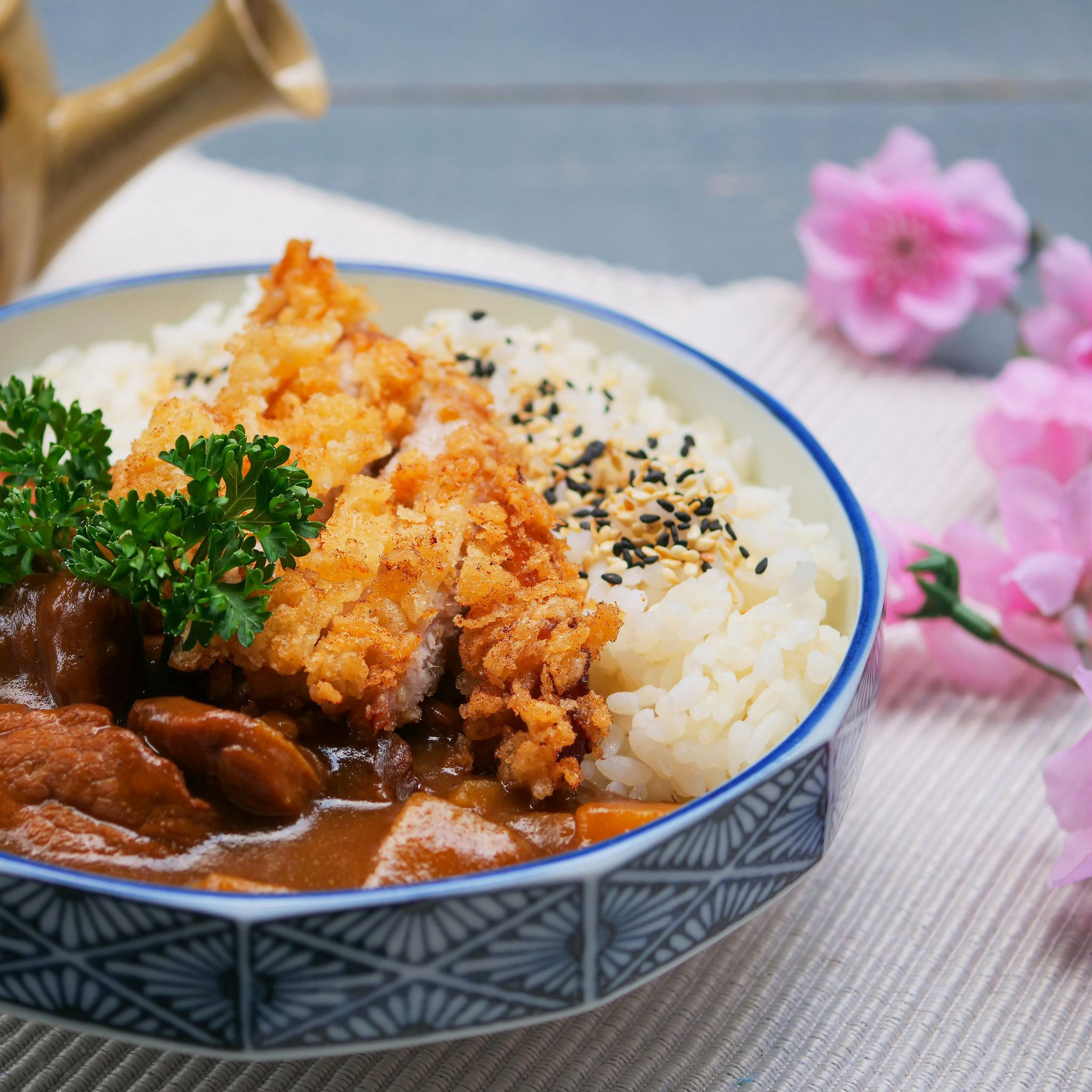 A blue and white bowl filled with a freshly cooked Japanese dish