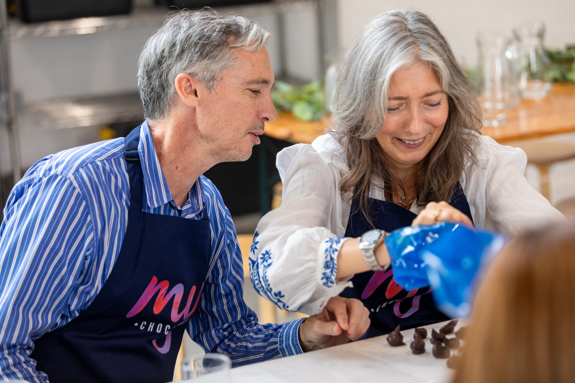 Two older people at a chocolate making class