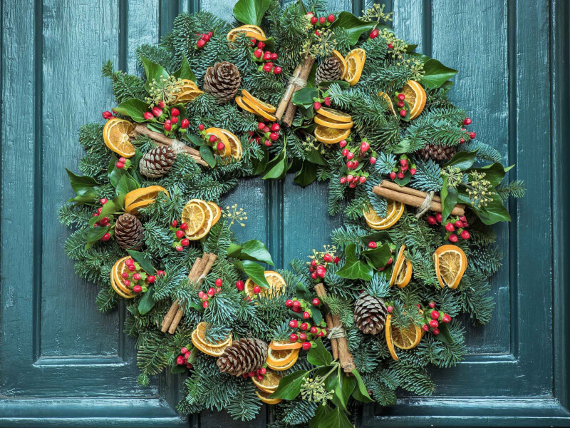 A handmade christmas wreath hanging from a door