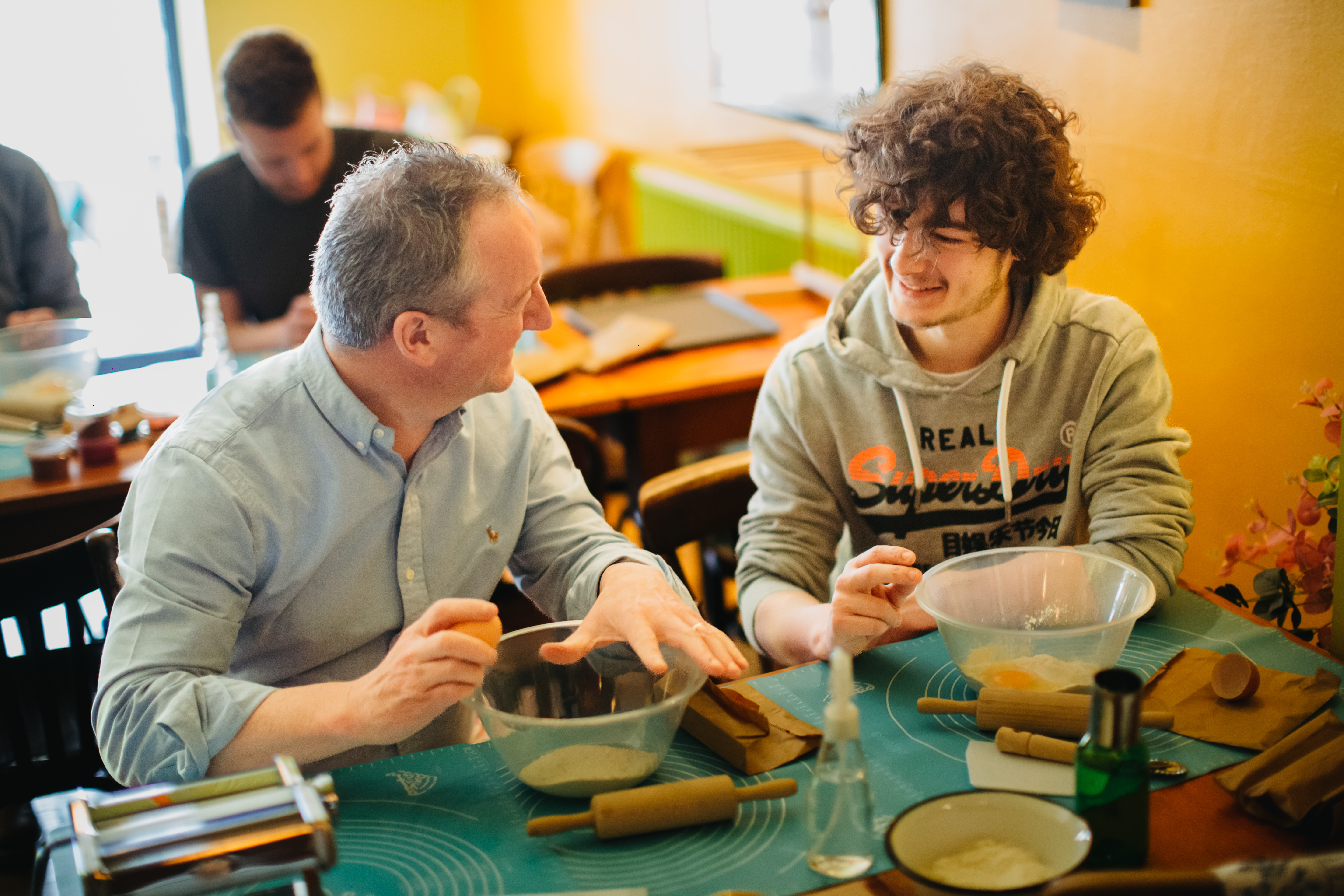 Two men are at a pasta making class