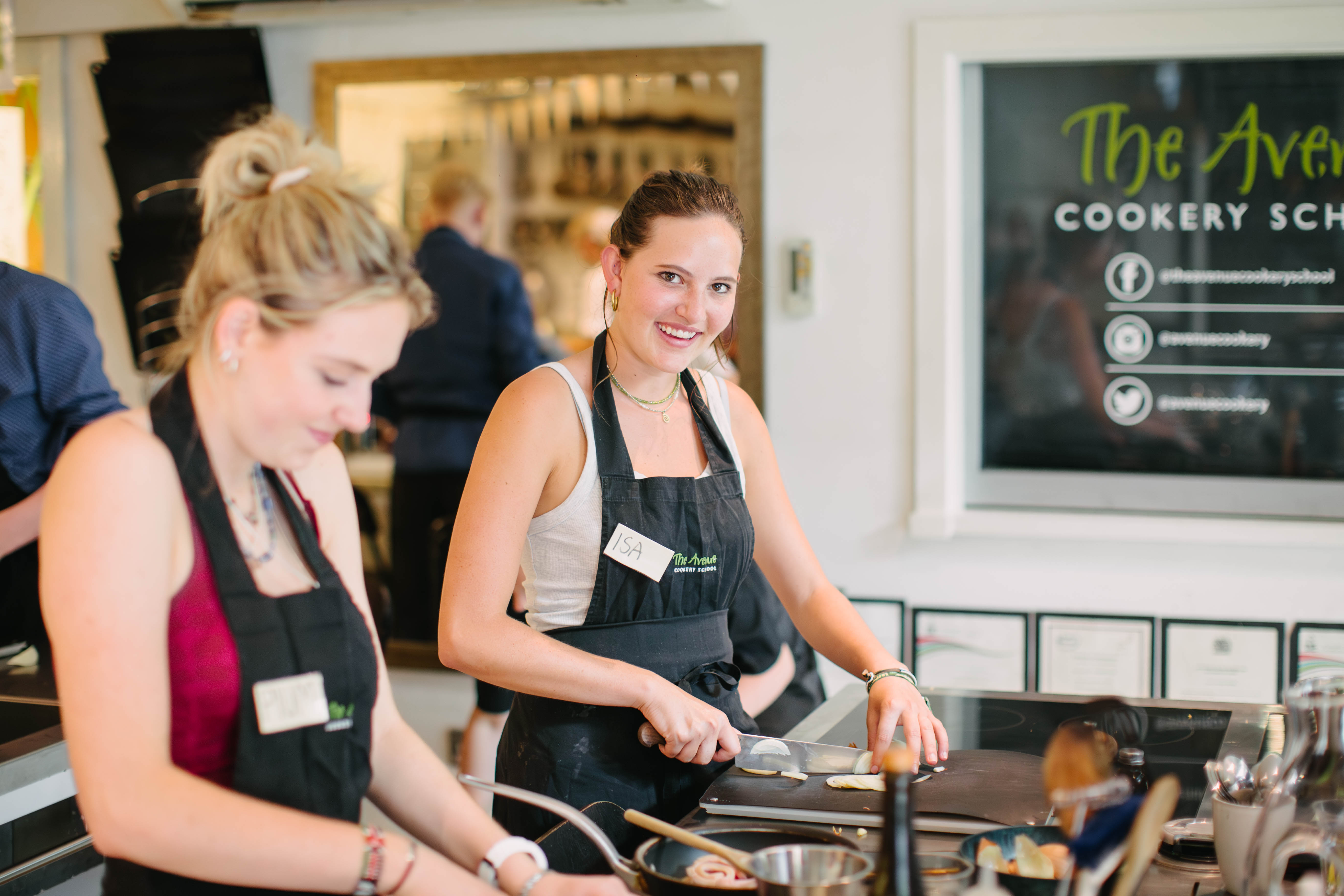 Two people are chopping ingredients at a cooking class