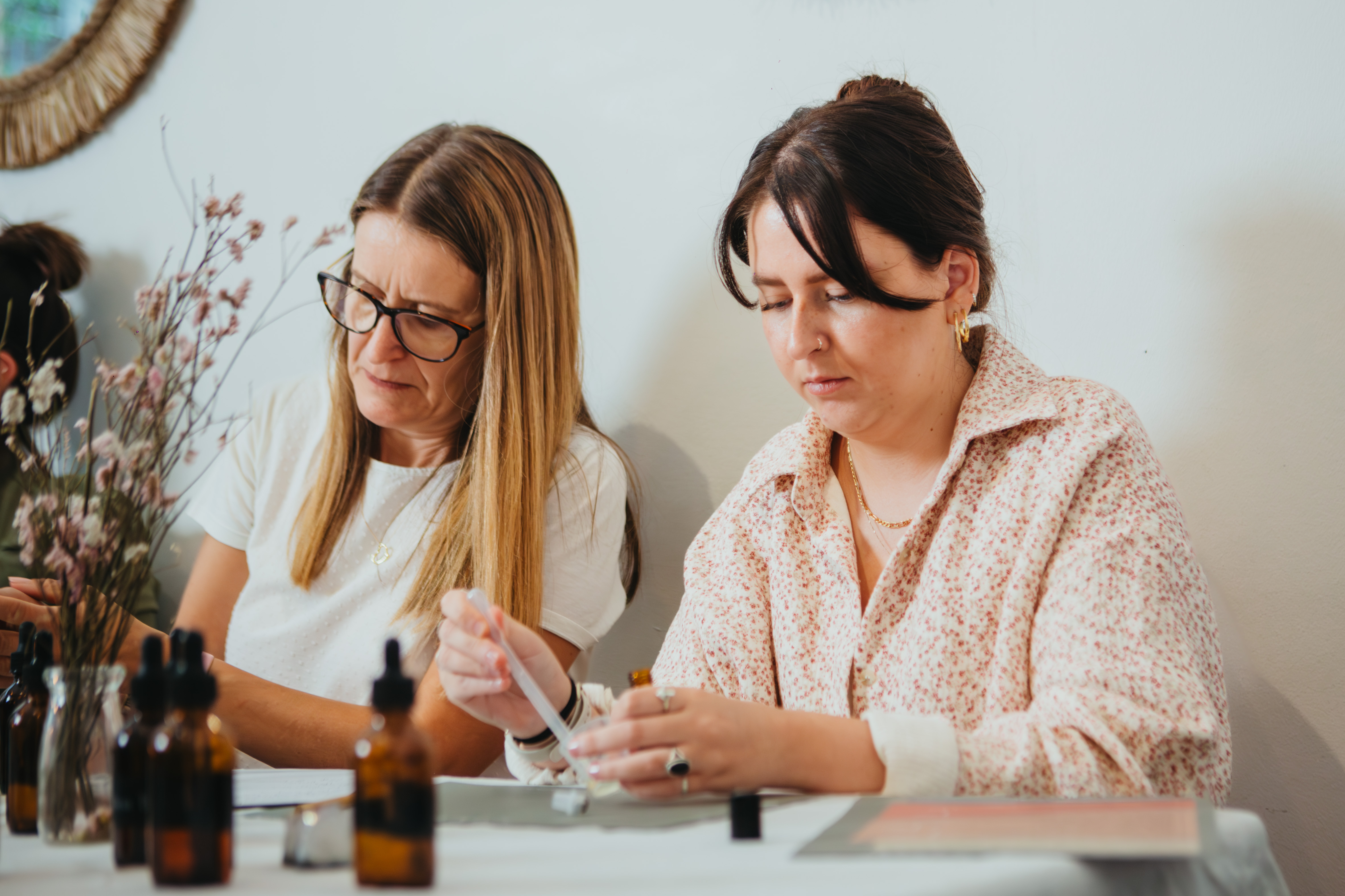 Two women are making perfume 