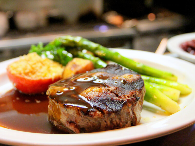 A cooked meal with meat and vegetables, presented on a plate